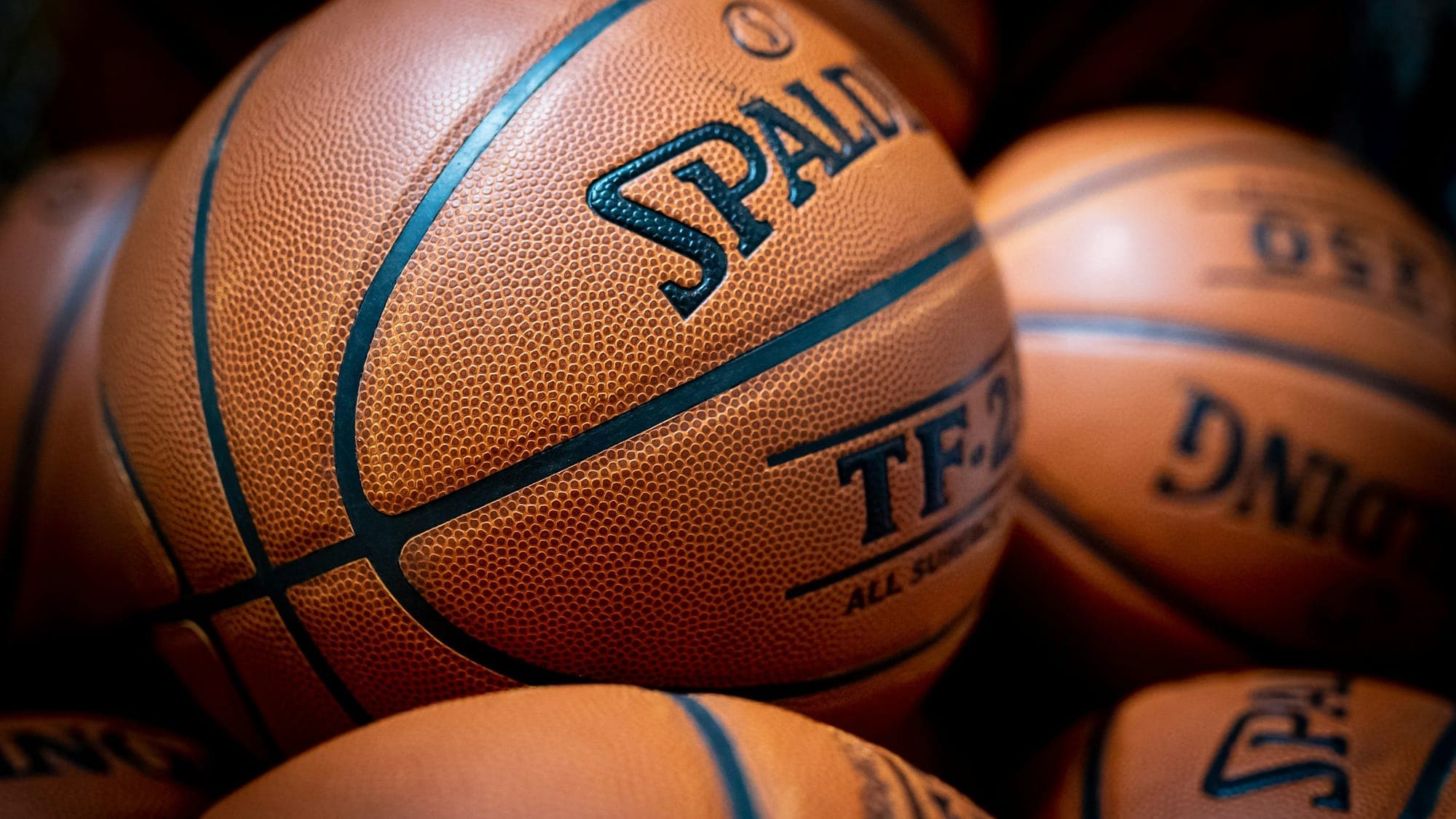A pile of Spalding basketballs stacked together