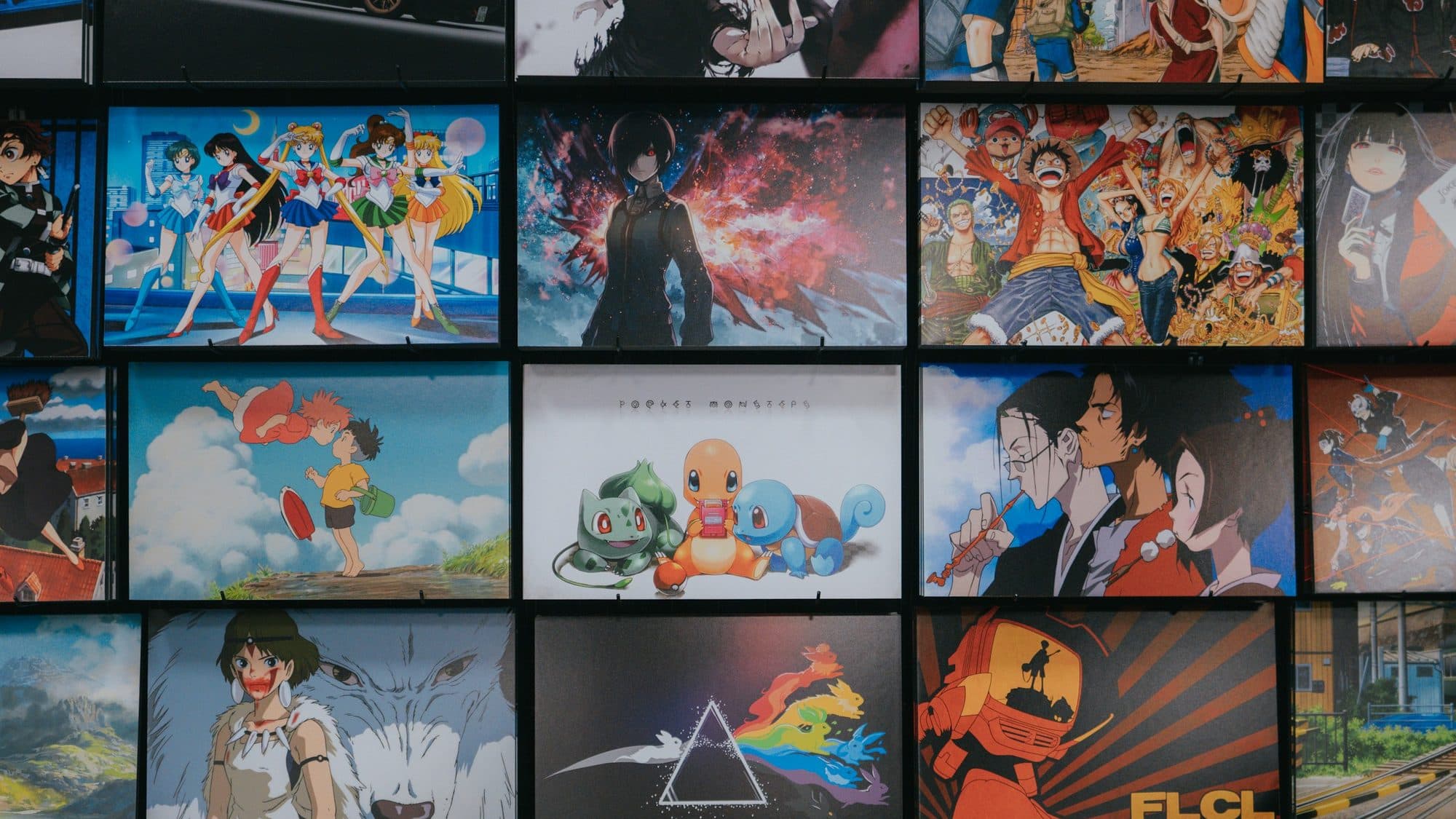 A wall covered in framed anime posters spanning many different series