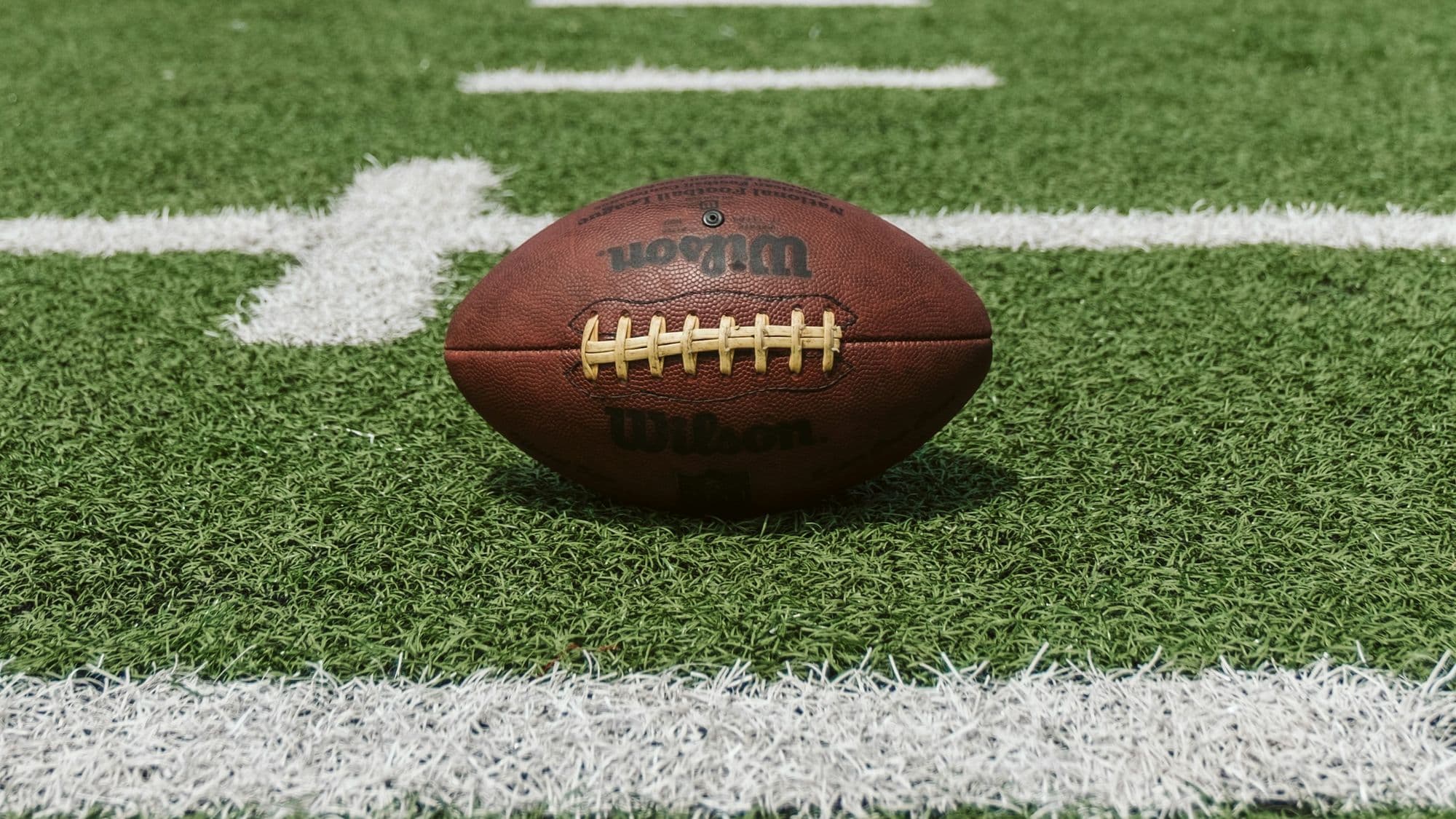 Football on the field yard markers, representing Monday Night Football coverage